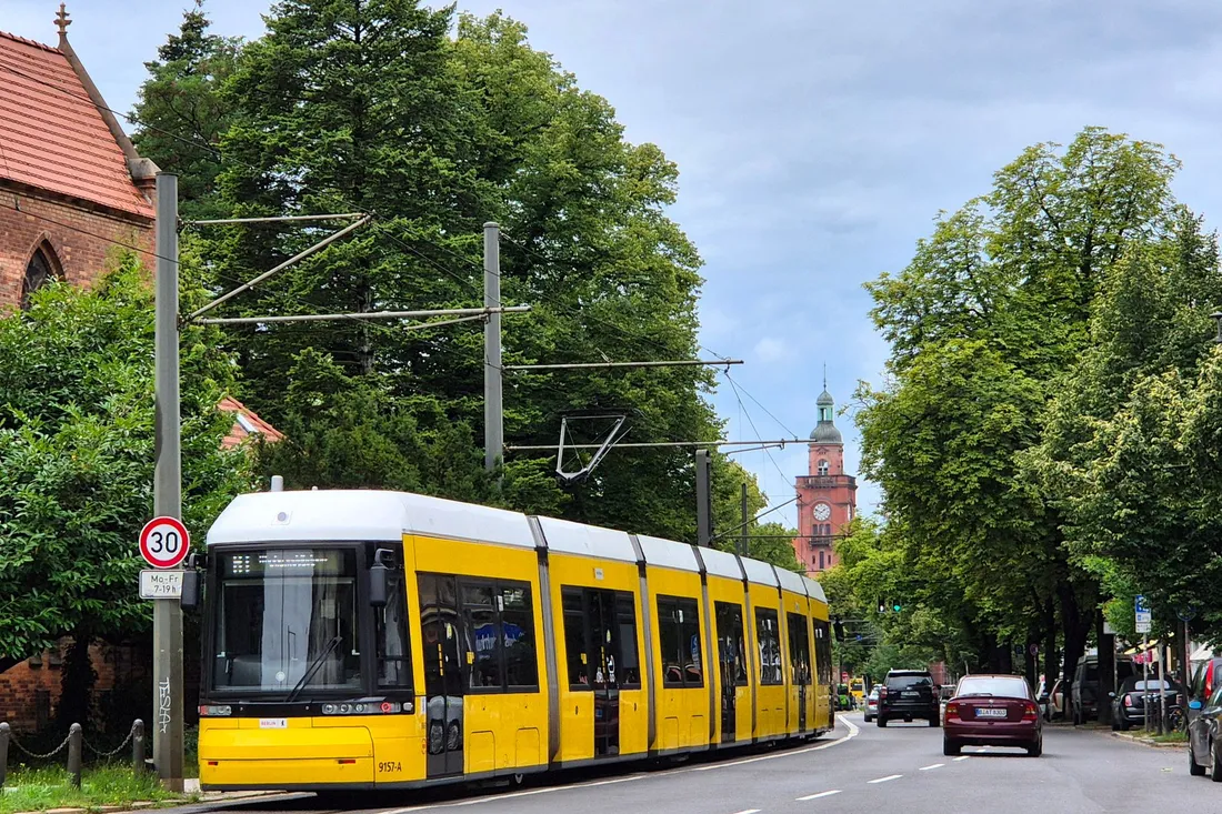 Straßenbahn fährt durch eine städtische Wohnstraße